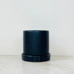 Cylindrical matte black plant pot for indoor use